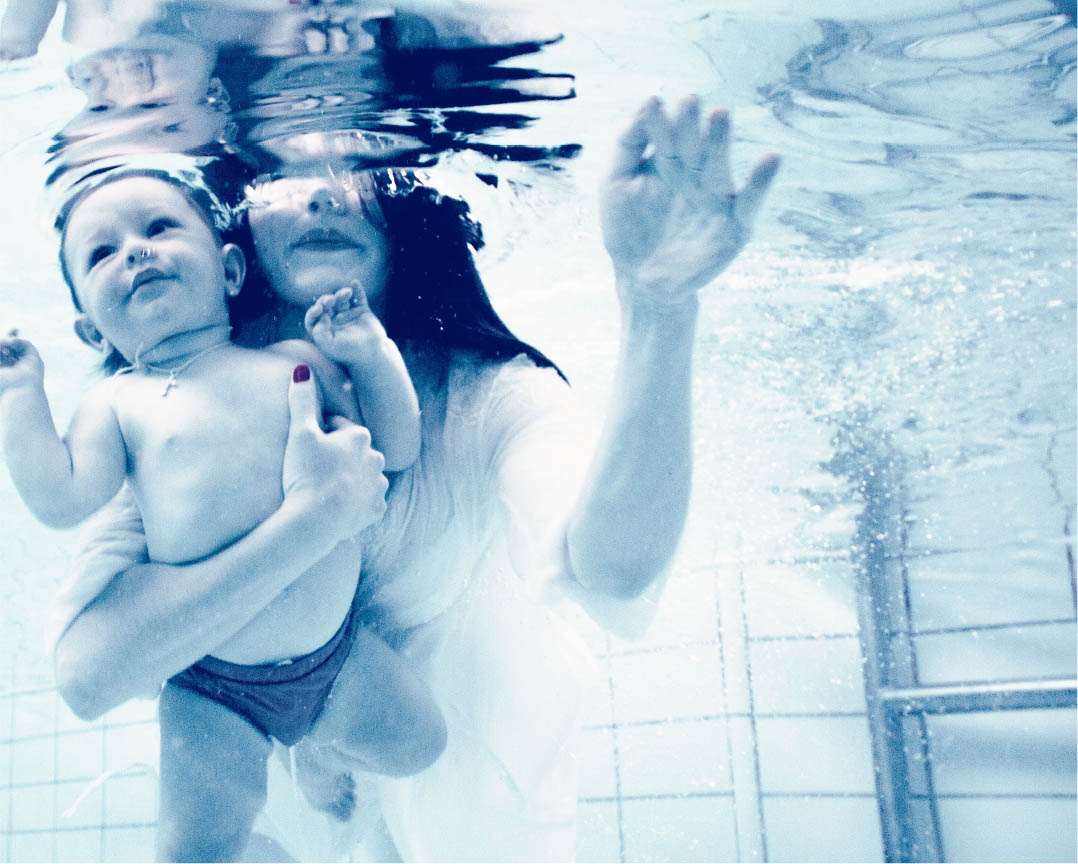 Mother anad baby submerged in a swimming pool