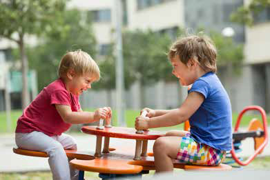 Two kids on a seesaw